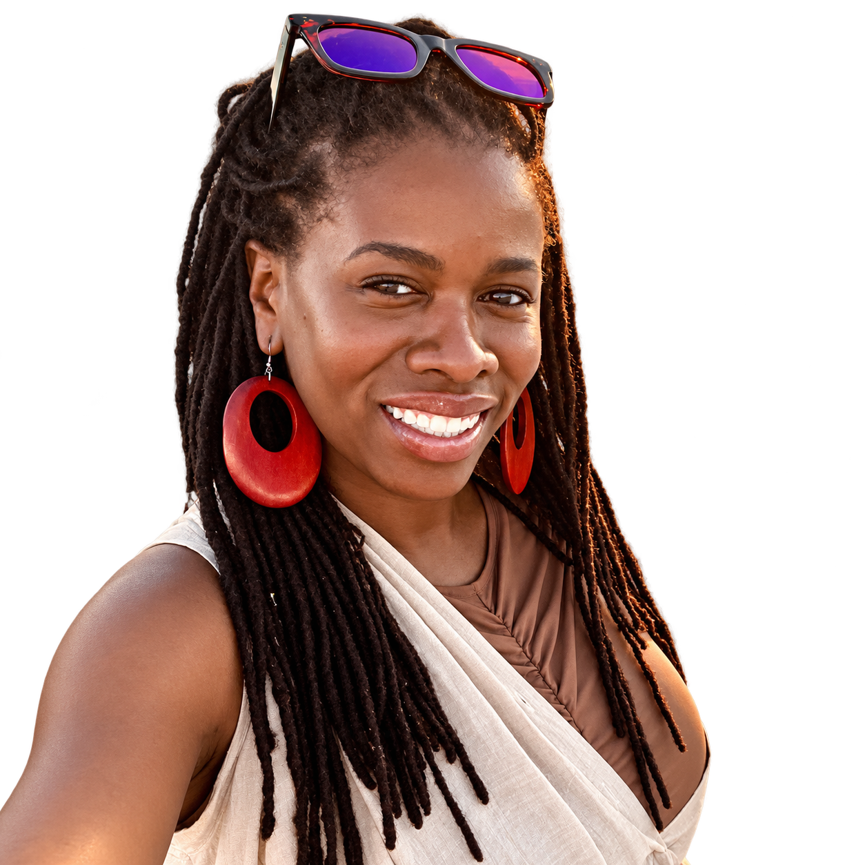 Tye Johnson smiling, with sunglasses in her hair and red earrings